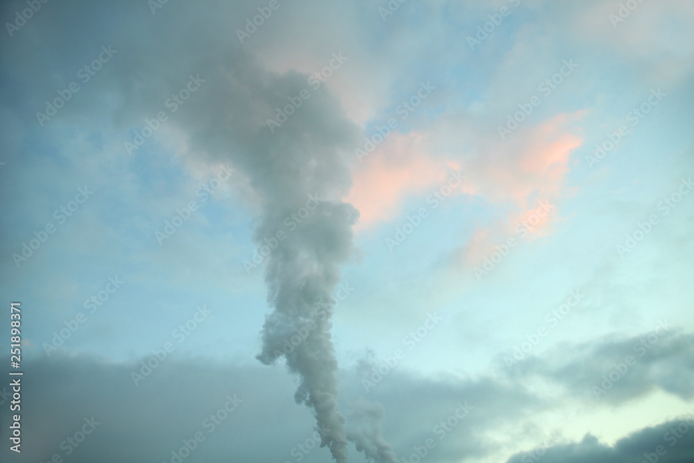 Colorful sunset sky with pink cloud and steam jet