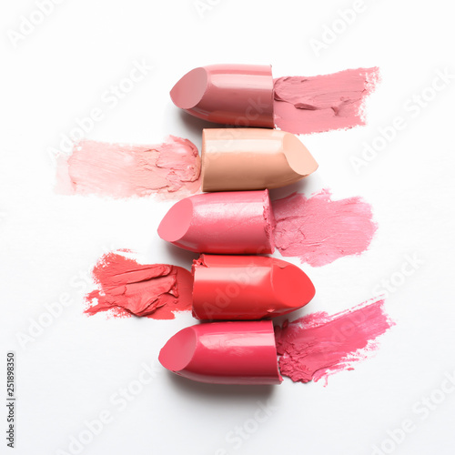 Different lipstick swatches on white background, top view photo
