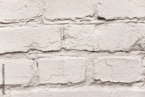 The texture of the old brick wall which is painted. Vertical photo of a brick wall. Texture for design