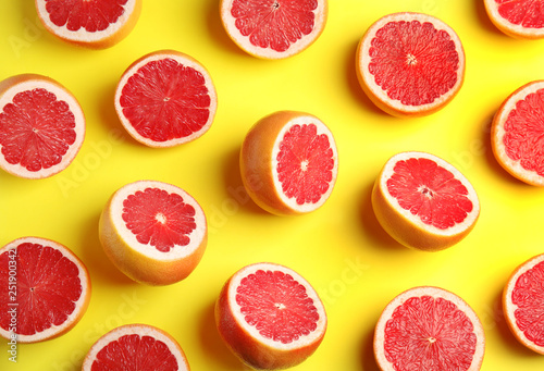 Fresh sliced ripe grapefruits on color background, flat lay