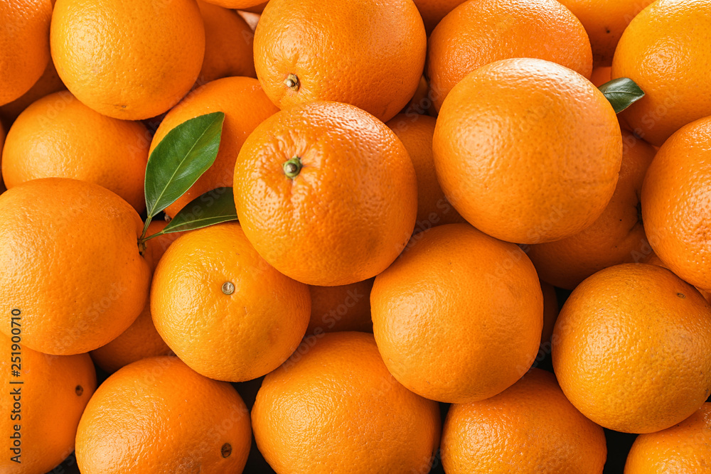 Pile of fresh ripe oranges with leaves as background, top view Pile of fresh ripe oranges with leaves as background, top view