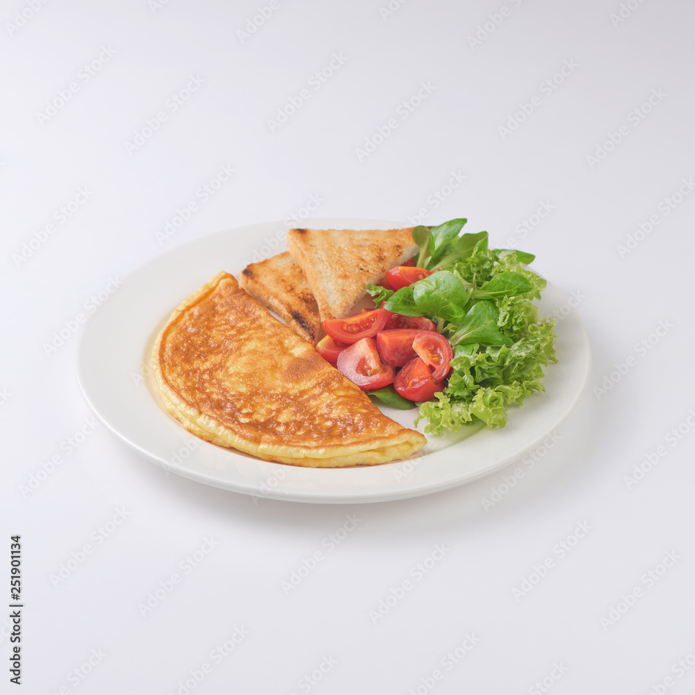 Plate of breakfast with omelette, toasts, tomato Plate of breakfast with omelette, toasts, tomato