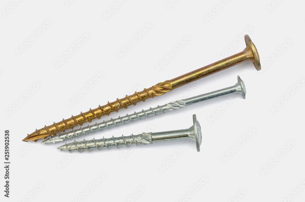 Metal fasteners. Three various tapping screws for construction on a white background, close-up.