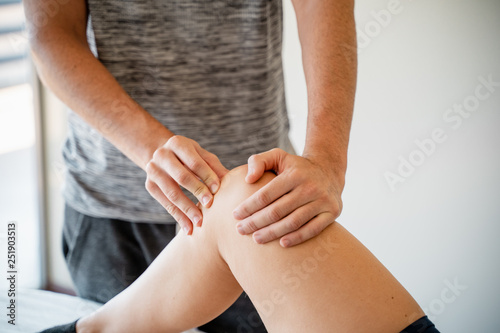 Fisioterapeuta tratando en rodilla de paciente