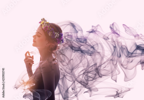 Charming woman spray perfume on her body. She has sexual attraction. photo