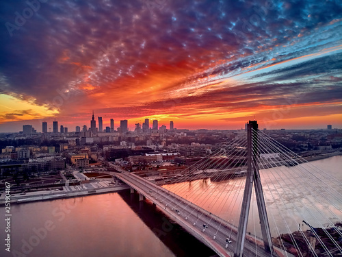 Beautiful panoramic aerial drone sunset view to Warsaw city center with skyscrapers and Swietokrzyski Bridge (En: Holy Cross Bridge) - is a cable-stayed bridge over the Vistula river in Warsaw, Poland photo