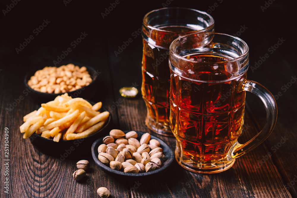 beer and snacks. friday party atmosphere, craft brewery, bar table. restaurant, pub, food concept. delicious lager drink, fries and salted nuts beer and snacks. friday party atmosphere, craft brewery, bar table. restaurant, pub, food concept. delicious lager drink, fries and salted nuts