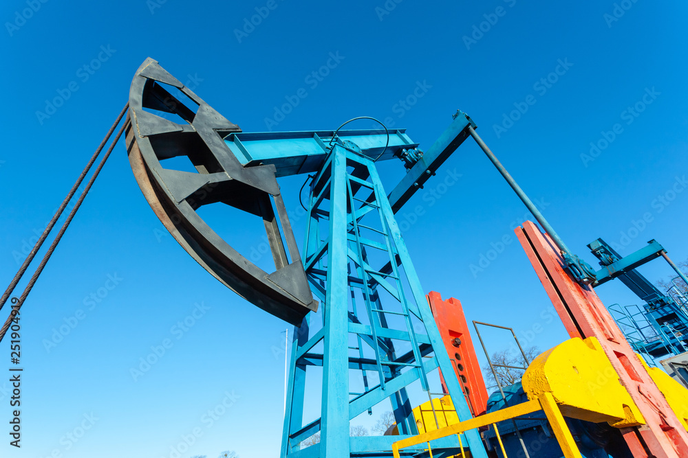 close-up of a sunlit oil extracting tower during operation close-up of a sunlit oil extracting tower during operation