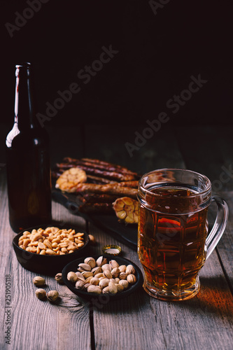 beer and snacks. friday party atmosphere, craft brewery, bar table. restaurant, pub, food concept. delicious lager drink, grilled sausages and salted nuts