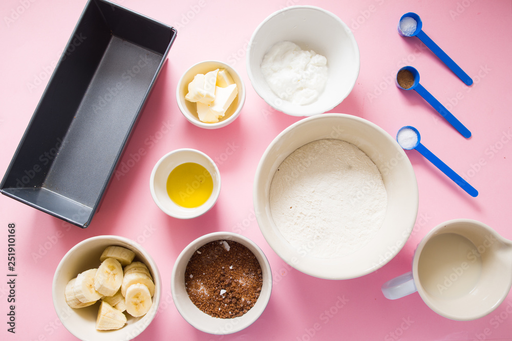 Visual guide made of single photo showing the different step to prepare a banana bread, ingredients to prepare the bread , eggs, flour, sugar, grreek yogurt, oi and butter, and banana,are displayed ov Visual guide made of single photo showing the different step to prepare a banana bread, ingredients to prepare the bread , eggs, flour, sugar, grreek yogurt, oi and butter, and banana,are displayed ov