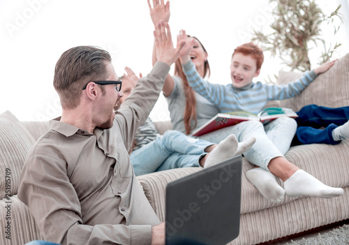 happy family giving high five in their living room