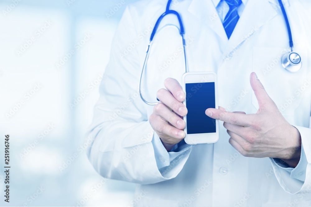 Young man doctor holding stethoscope