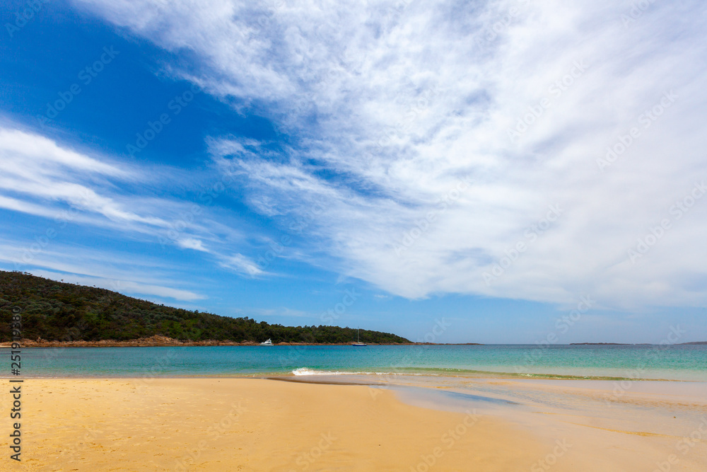 Turquoise ocean water and yellow sand  at Fingal Bay, New South Wales, Australia