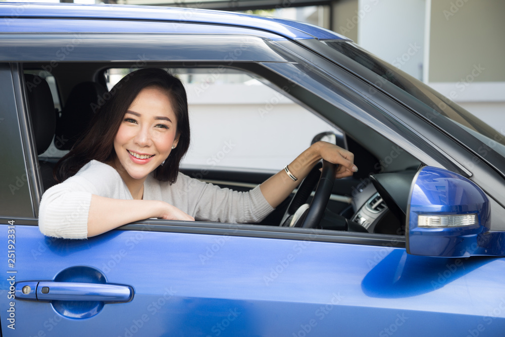 Asian women driving a car and smile happily with glad positive expression during the drive to travel journey, People enjoy laughing transport and relaxed happy woman on roadtrip vacation concept