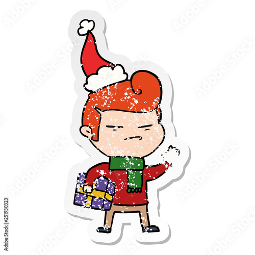 distressed sticker cartoon of a cool guy with fashion hair cut wearing santa hat