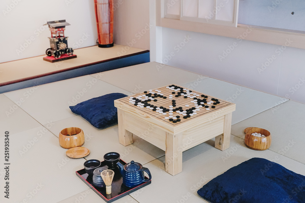 Desk for board game wei-Chi and black and white bones on japanese room  style . Go or wei-Chi - traditional chinese board game. Stock Photo | Adobe  Stock