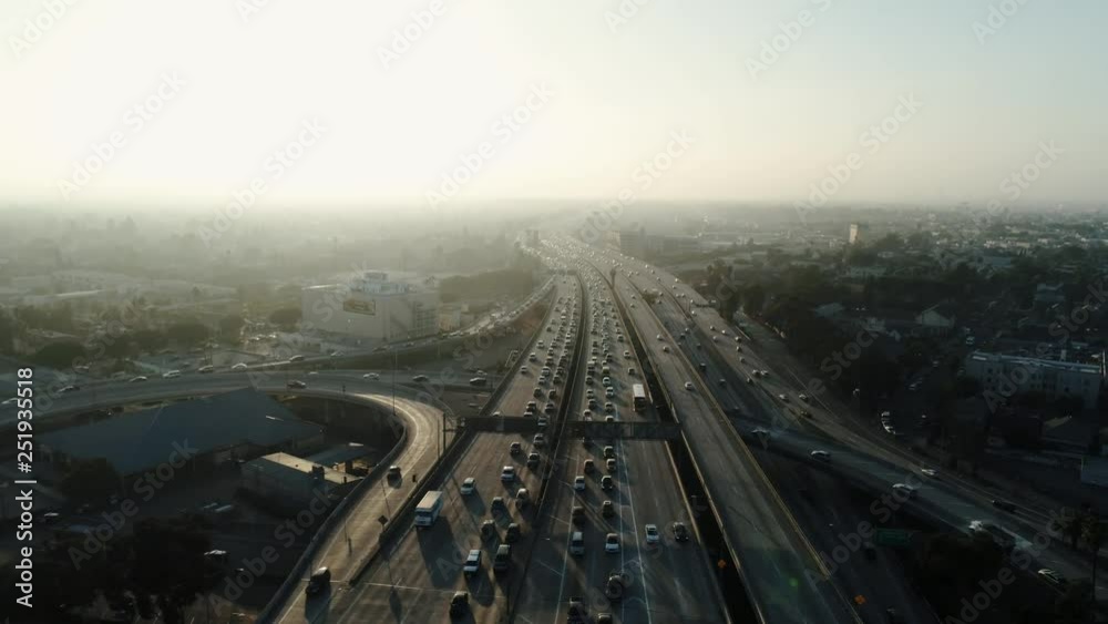 Above the highway in heavy traffic, sunset, cinematic aerial shot Above the highway in heavy traffic, sunset, cinematic aerial shot