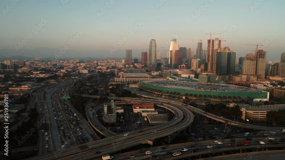 above the highway with traffic during sunset in downtown, aerial shot