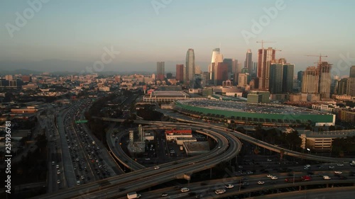 above the highway with traffic during sunset in downtown, aerial shot