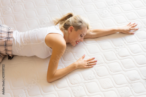 Woman enjoying her new comfortable mattress photo