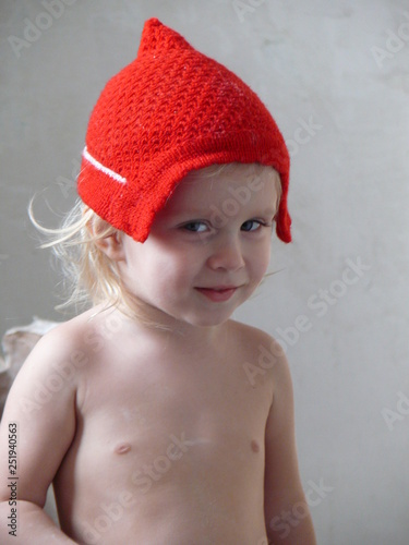 baby in knitted red hat - Santa's childhood
