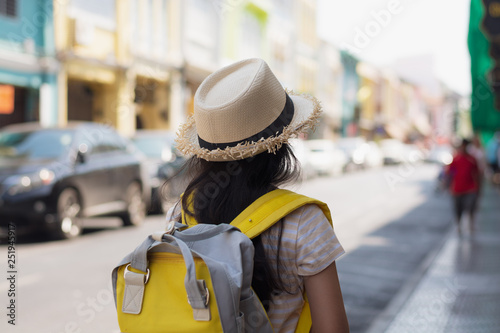 Young girl Traveler with backpack standing in old town, Phuket, Thailand. © surasaki