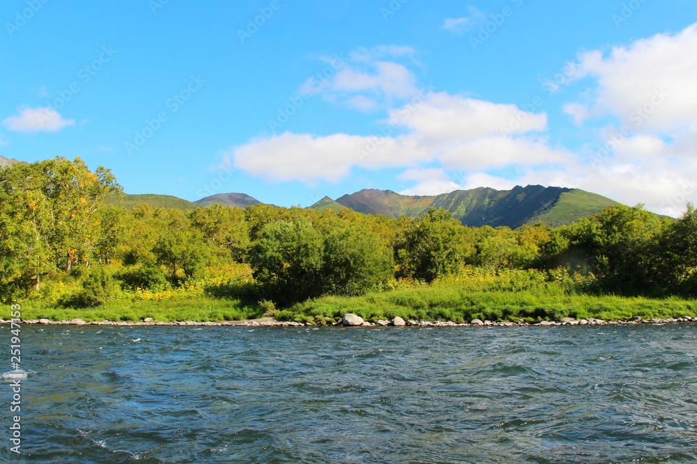 Beautiful Bystraya Malkinskaya river flows in valley between hills on the Kamchatka Peninsula, Russia.