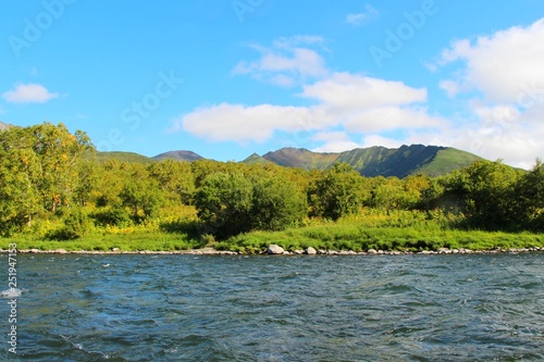 Beautiful Bystraya Malkinskaya river flows in valley between hills on the Kamchatka Peninsula, Russia.