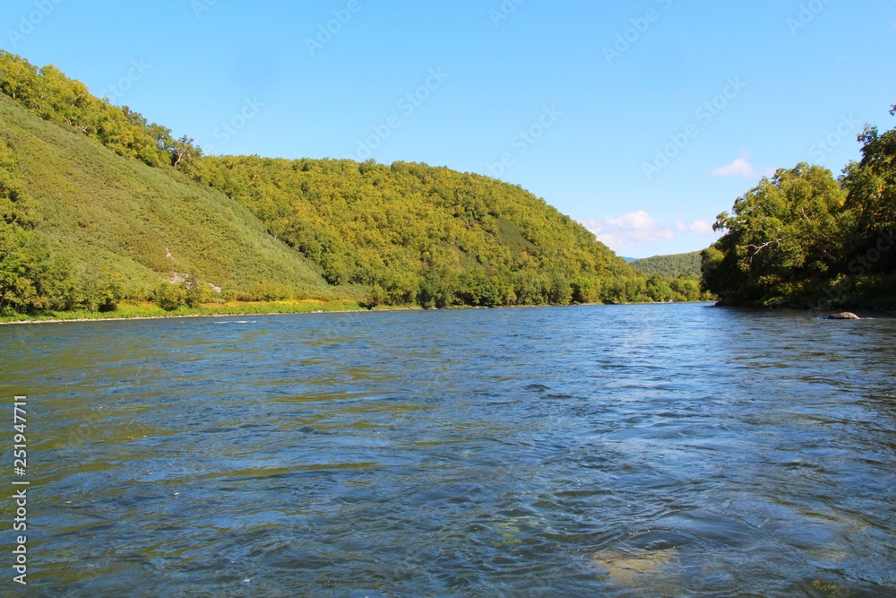 Beautiful Bystraya Malkinskaya river flows in valley between hills on the Kamchatka Peninsula, Russia. Beautiful Bystraya Malkinskaya river flows in valley between hills on the Kamchatka Peninsula, Russia.