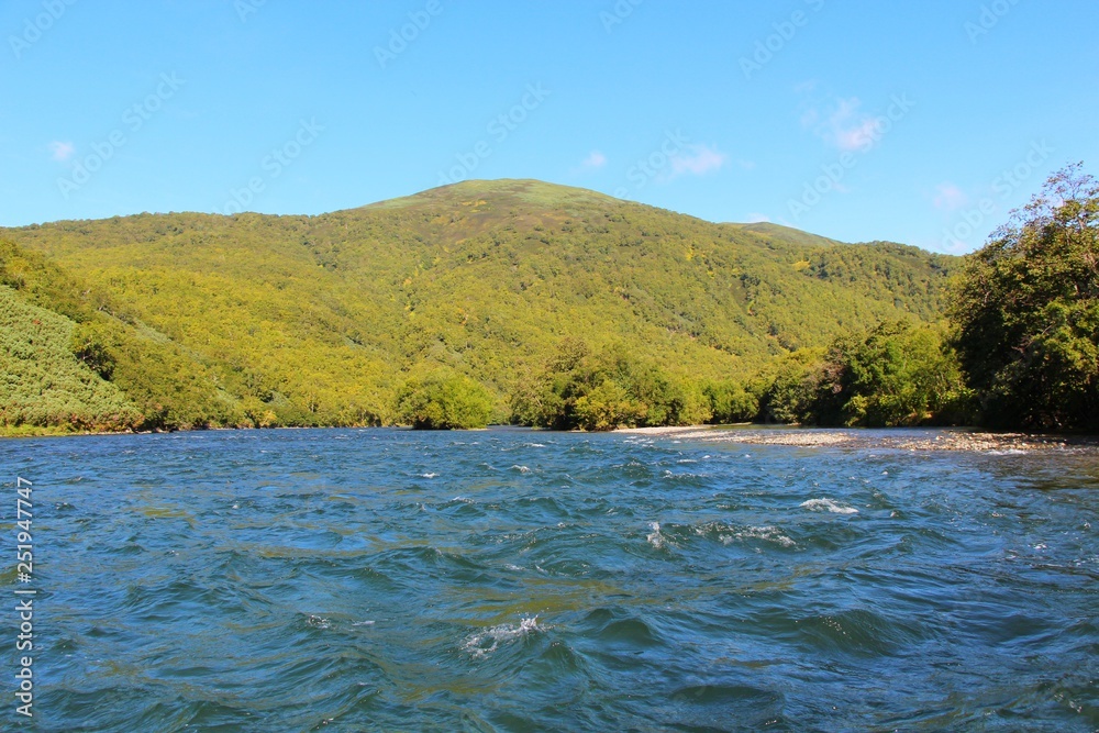 Beautiful Bystraya Malkinskaya river flows in valley between hills on the Kamchatka Peninsula, Russia. Beautiful Bystraya Malkinskaya river flows in valley between hills on the Kamchatka Peninsula, Russia.