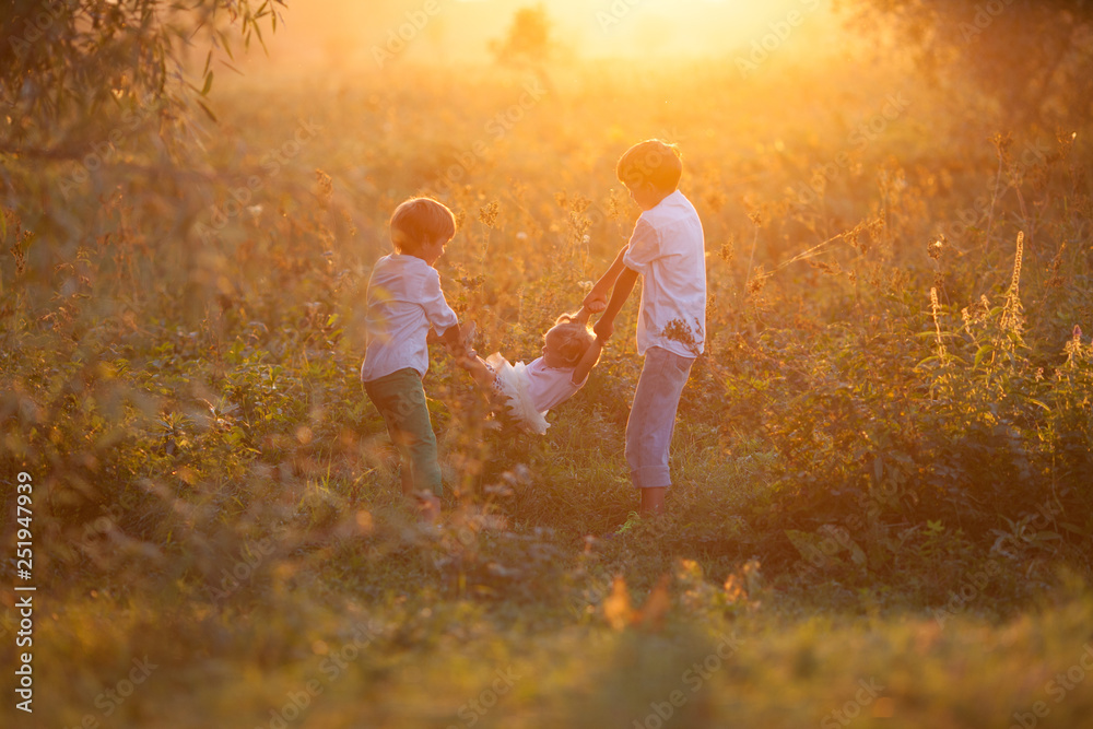 Fototapeta premium Portrait of pretty happy sister and brothers in suummer, outdoor