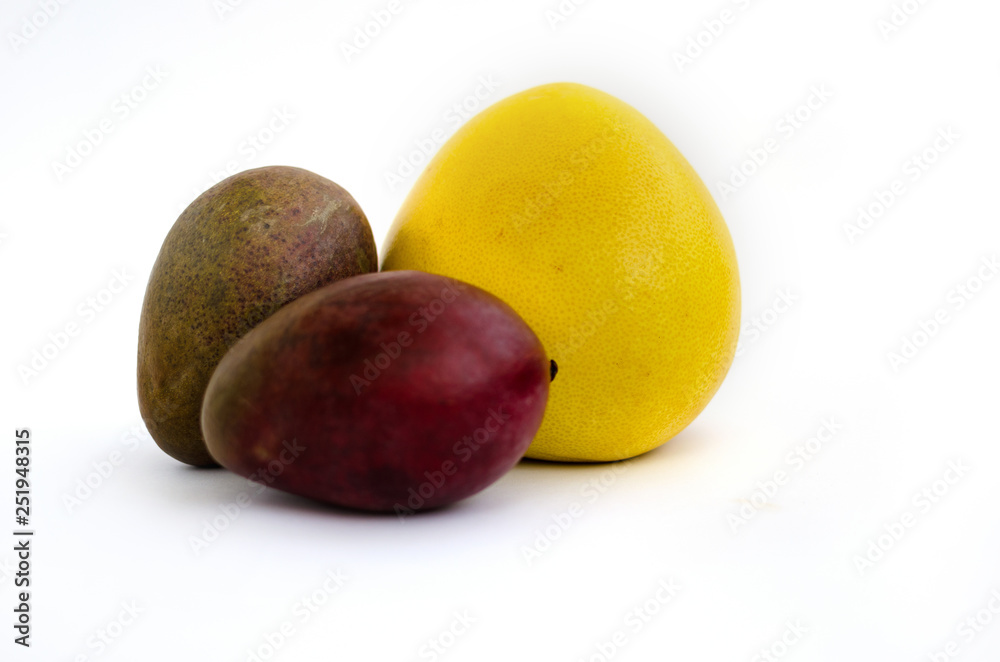 mango and pomelo isolated on white background partially out of focus