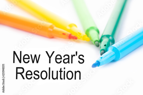 Colorful felt-tip pen and New Year's Resolution words on white background.