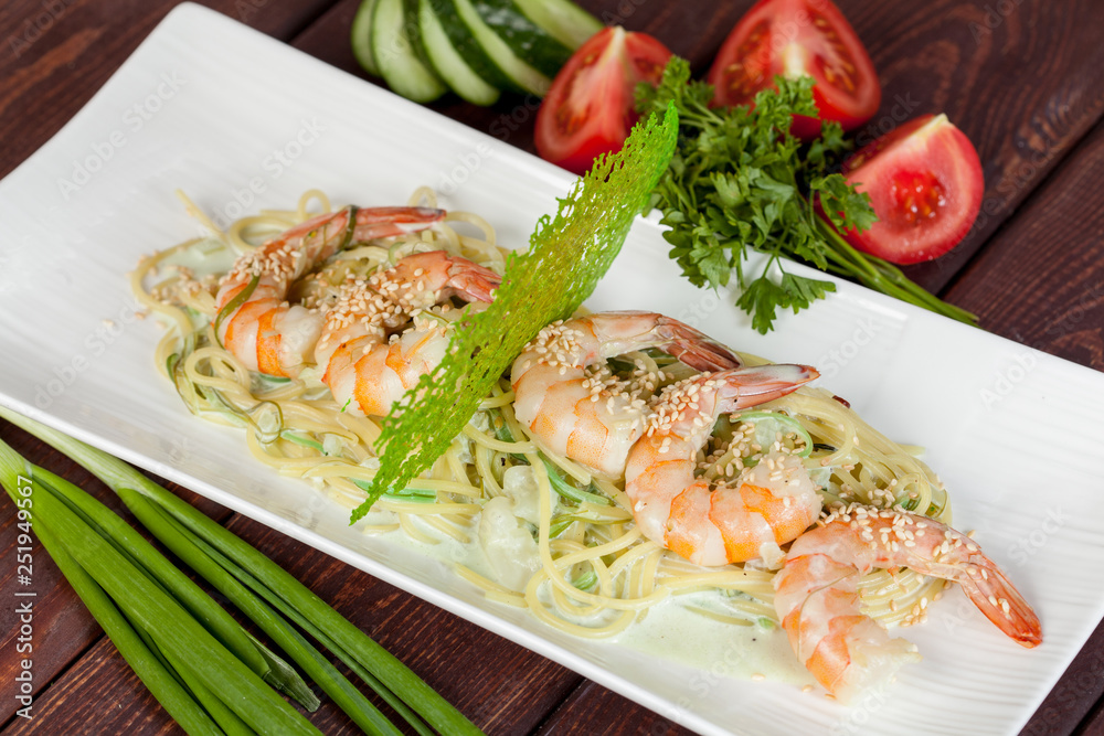 large and appetizing ready-made shrimps beautifully laid out with greens and vegetables for design solutions in cooking large and appetizing ready-made shrimps beautifully laid out with greens and vegetables for design solutions in cooking