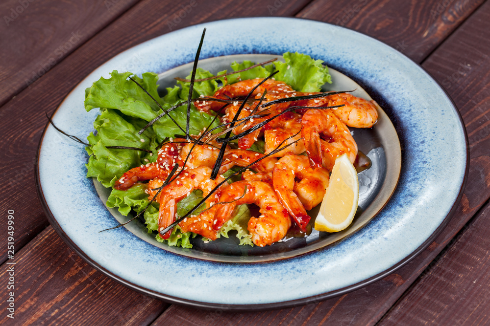 large and appetizing ready-made shrimps beautifully laid out with greens and vegetables for design solutions in cooking large and appetizing ready-made shrimps beautifully laid out with greens and vegetables for design solutions in cooking