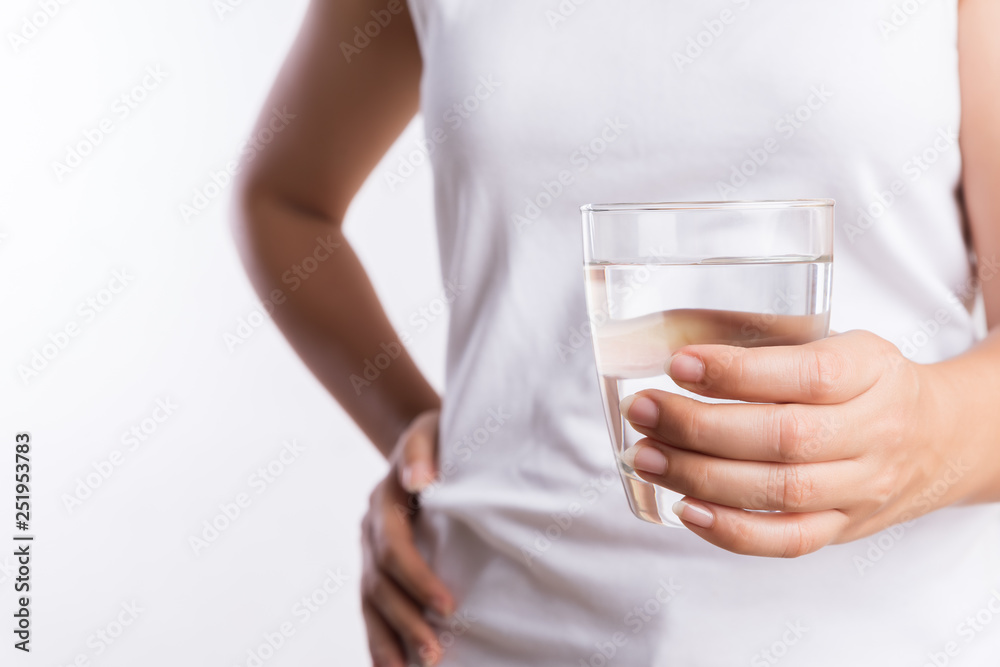 A glass of clean mineral water in woman's hands. Concept of environment protection, healthy drink and healthcare. A glass of clean mineral water in woman's hands. Concept of environment protection, healthy drink and healthcare.