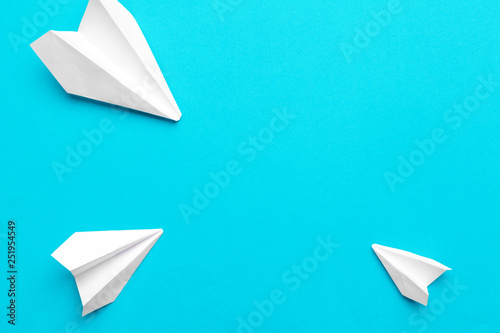 white paper airplane on a blue background