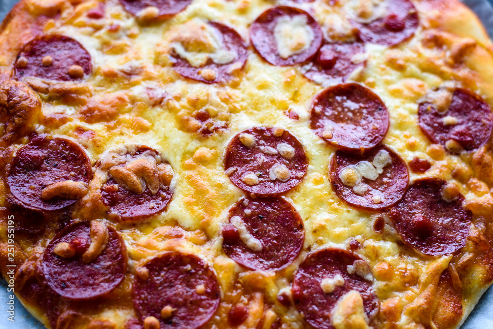 close up of baked pizza with pepperoni and cheese close up of baked pizza with pepperoni and cheese