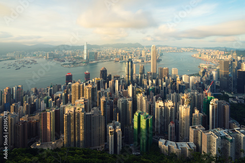 Aerial view of Hong Kong skyline and Victoria Harbor with blue sky in Hong Kong. Asia..