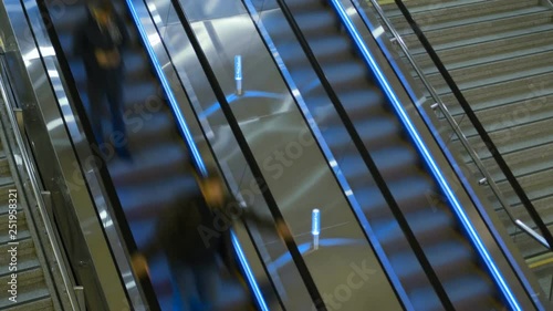 timelapse people on escalator inside railwy or train station, modern airport photo