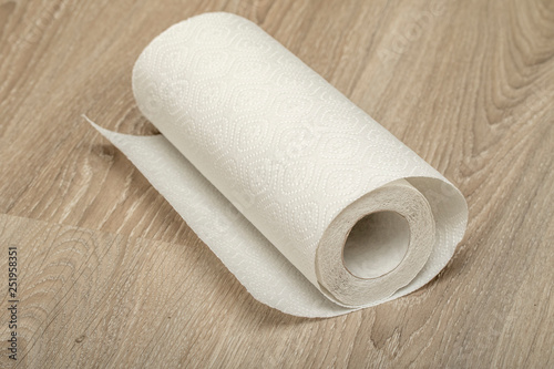 white paper towel roll on wooden background