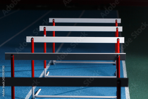 Row of hurdles for sprint training on the lane photo
