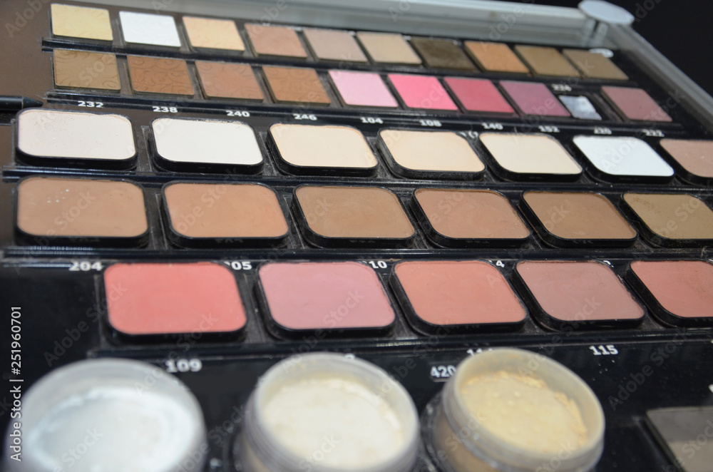 set of makeup brushes on the background of color eye shadow palette on the table set of makeup brushes on the background of color eye shadow palette on the table