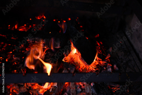 Smoldering ashes of a bonfire. Fire flame in a brick barbecue