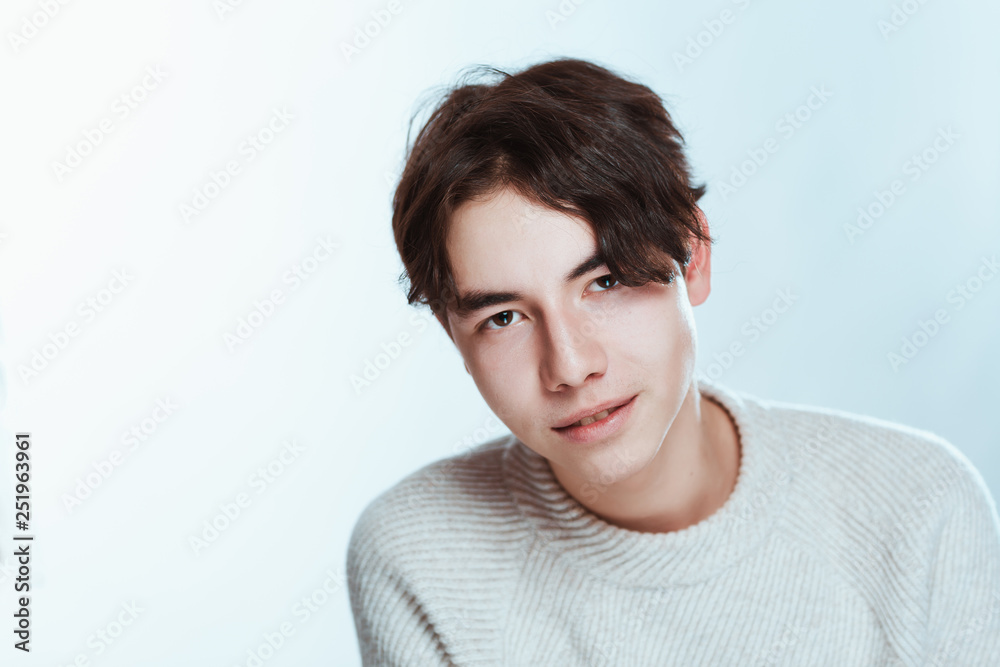 Studio portrait young man in grey sweater on white background Studio portrait young man in grey sweater on white background