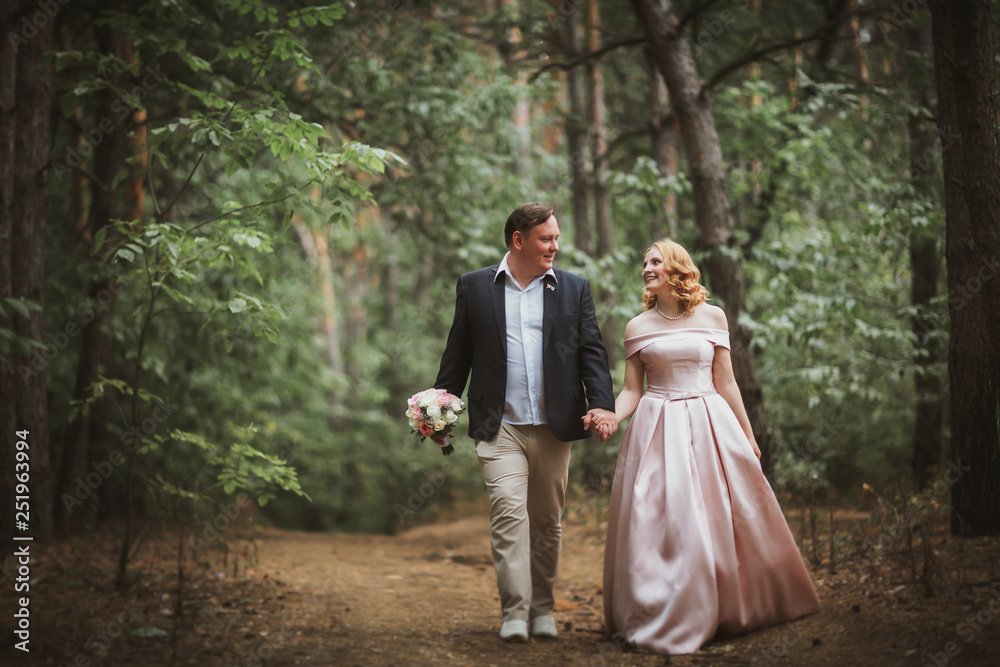 bride and groom kissing in the summer forest bride and groom kissing in the summer forest