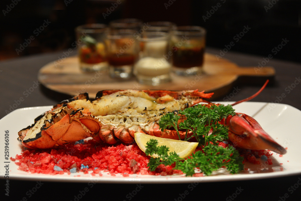 Baked canadian Lobster with Cheese on Plate in Hotel restaurant Baked canadian Lobster with Cheese on Plate in Hotel restaurant