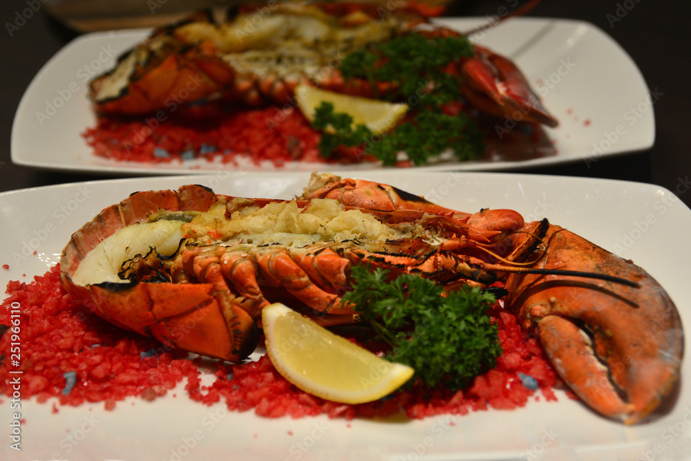 Baked canadian Lobster with Cheese on Plate in Hotel restaurant Baked canadian Lobster with Cheese on Plate in Hotel restaurant
