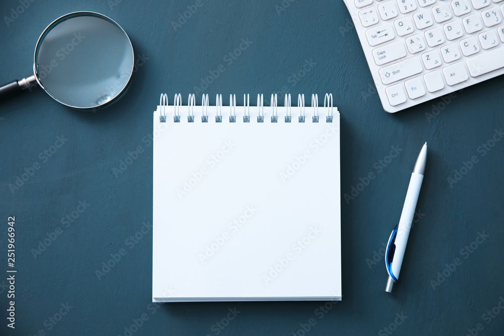 notepad with keyboard and magnifier