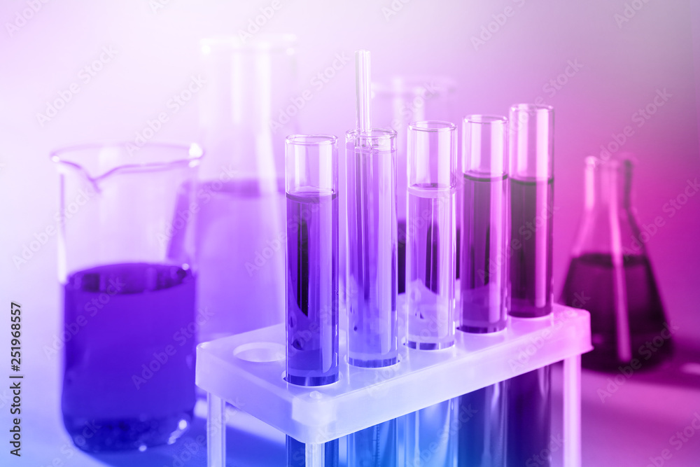 Test tubes with colorful liquids in holder, closeup